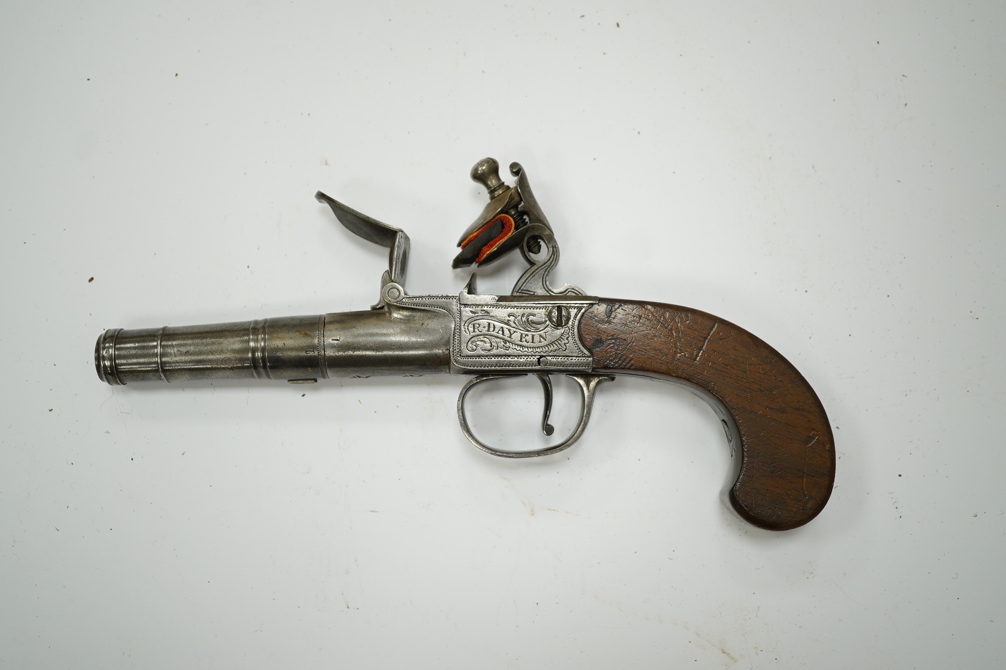 A cannon barrel flintlock boxlock travelling pistol by R. Daykin of Nottingham, with turn off cannon barrel, Tower private proof marks, signed frame upon foliate engraved background, slab walnut grip and sliding trigger